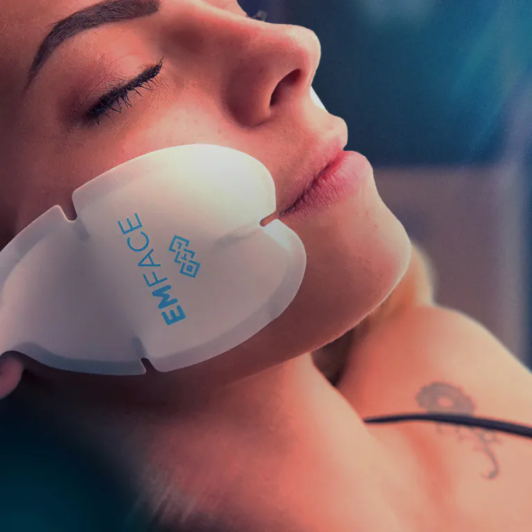 EMFACE treatment photograph, Square Mile Clinic, City of London EMFACE facial treatment with a cheek applicator, available at Square Mile Clinic, City of London